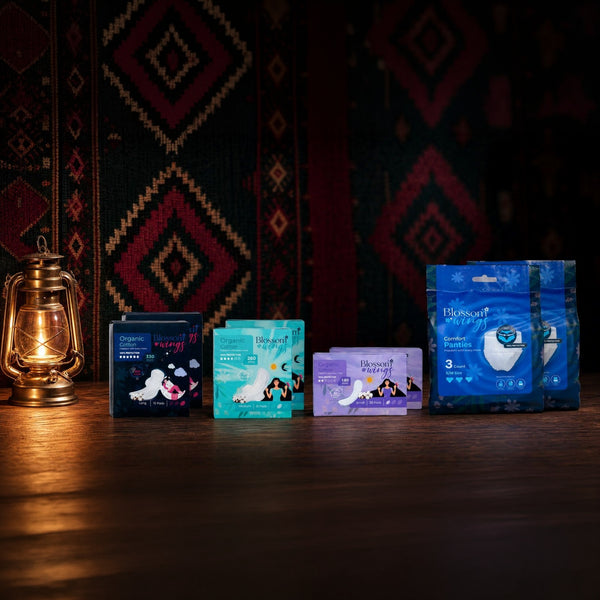 The Blossom Wings National Day Set: two packs of every product, 180mm, 260mm and 330mm pads and Comfort Panties, beside a lantern